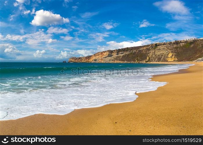 Nazare coast and sandy beach, atlantic ocean, Portugal in a beautiful summer day
