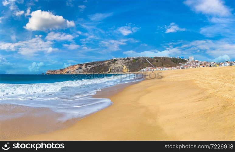 Nazare coast and sandy beach, atlantic ocean, Portugal in a beautiful summer day