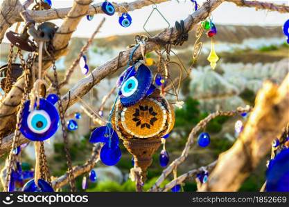 Nazars, turkish amulets, hanging on old dry tree, Cappadocia. Nazars on tree