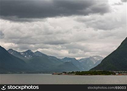 Near Andalsnes along the Romsdalsfjorden under a cloudy sky, Norway. Along the Romsdalsfjorden near Andalsnes, Norway
