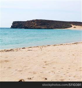 near sandy beach sky and mountain in oman arabic sea