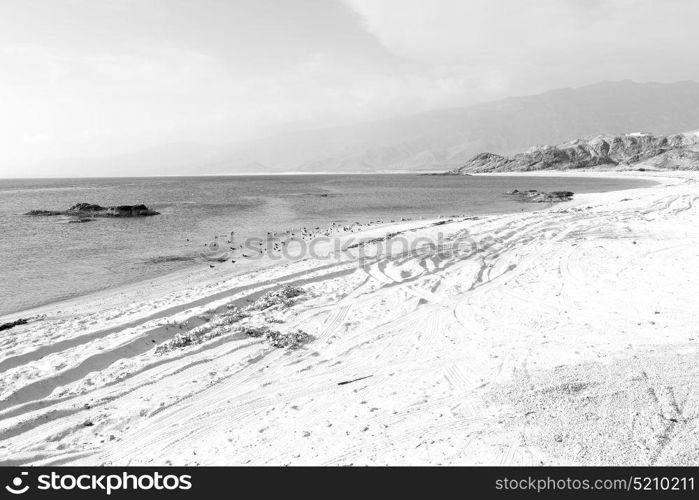 near sandy beach sky and mountain in oman arabic sea