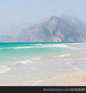 near sandy beach sky and mountain in oman arabic sea the hill