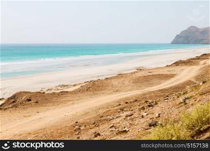 near sandy beach sky and mountain in oman arabic sea the hill