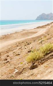 near sandy beach sky and mountain in oman arabic sea the hill