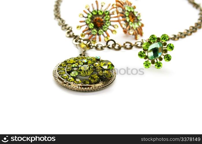 Necklace,earrings,ring with green stones isolated on white background.
