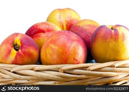 nectarines in water drops to a wattled basket