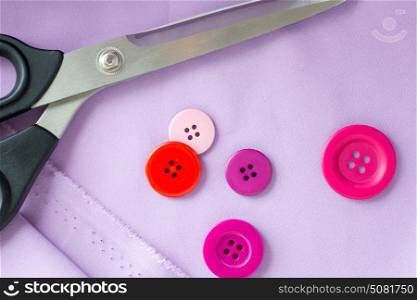 needlework and tailoring concept - scissors, sewing buttons and cloth. scissors, sewing buttons and cloth
