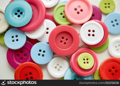 needlework and tailoring concept - sewing buttons. many sewing buttons