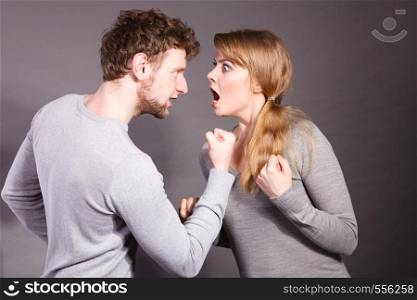 Negative emotions concept. People in fight. Husband and wife arguing and yelling on each other. Expressive and emotional couple having argument.. People in fight. Young couple arguing.
