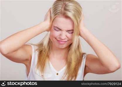 Negative human emotions, facial expressions, reaction attitude. Closeup stressed business woman covers ears with hands