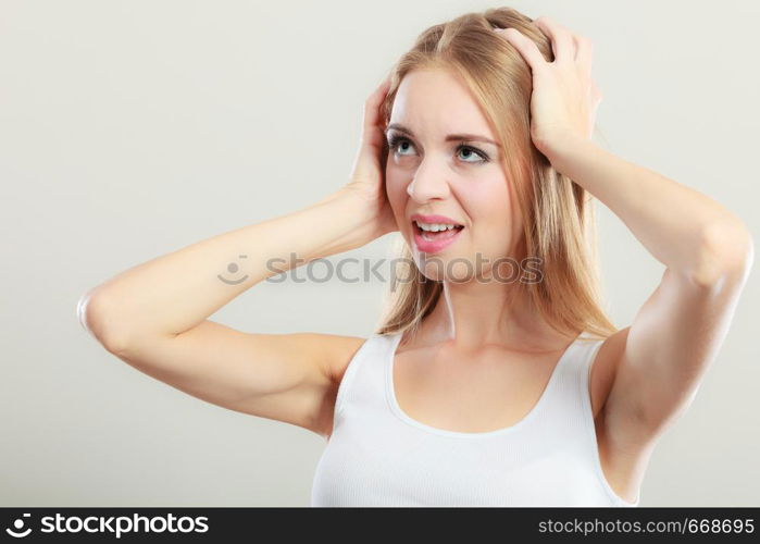 Negative human emotions, facial expressions, reaction attitude. Closeup stressed young woman covers ears with hands