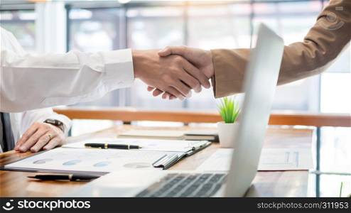 Negotiating business, Two confident business man shaking hands with partners together after finishing up a meeting succeeded Connection Deal Concept