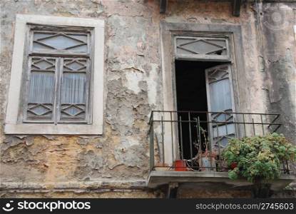 neighborhood poverty with damaged balcony and window in Lisbon, Portugal