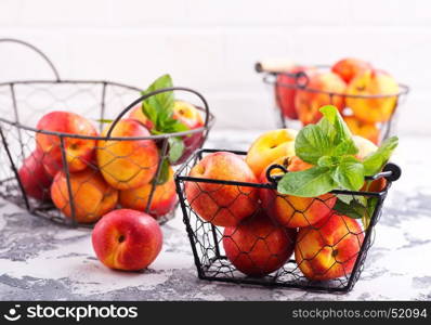 nektarins in metal basket and on a table