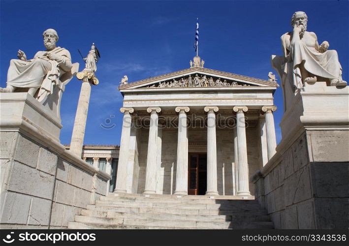 Neoclassical Academy of Athens in Greece showing main building and statues of ancient Greek philosophers Plato (left), Socrates (right) and goddess Pallas Athena (behind Plato). The Academy of Athens is the highest research establishment in the country and one of the major landmarks of the city.