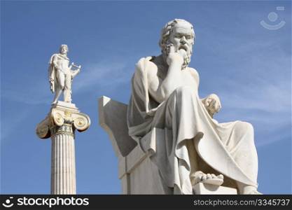 Neoclassical statues of Socrates (Greek ancient philosopher) and Apollo (god of the sun, medicine and the arts) in front of the Academy of Athens, Greece.