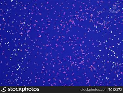 Neon pink sparkles in form of heart on navy blue background. Festive background for wallpaper, wrapping, backdrop, print or banner. Flat lay style.. Neon pink sparkles in form of heart on blue background. Festive background for wallpaper, wrapping, backdrop, print or banner.
