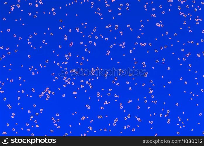 Neon pink sparkles in form of heart on navy blue background. Festive background for wallpaper, wrapping, backdrop, print or banner. Flat lay style.. Neon pink sparkles in form of heart on blue background. Festive background for wallpaper, wrapping, backdrop, print or banner.