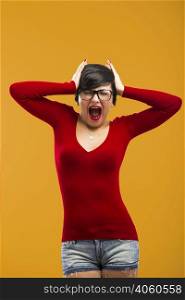 Nerd girl angry with something, aganist a yellow background