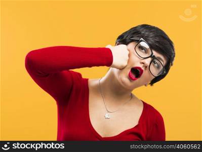 Nerd girl punching himself, against a yellow background