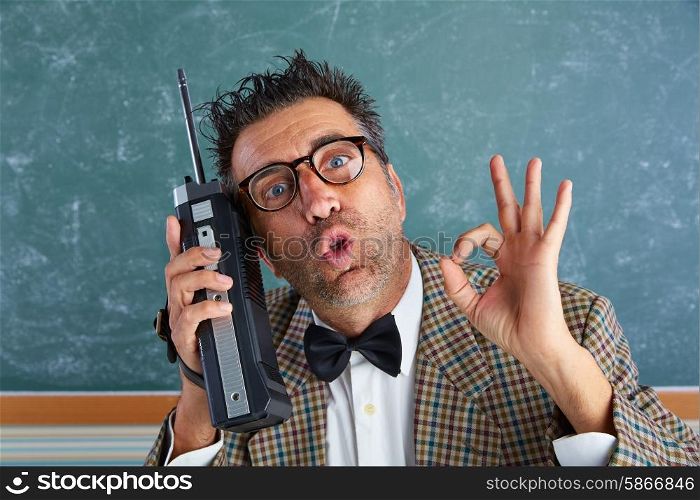 Nerd silly private investigator with retro walkie talkie on teacher balckboard