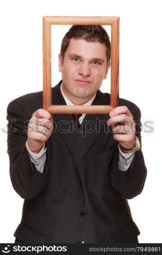 Nerdy funny business man guy framing his face with wooden empty picture frame isolated on white background