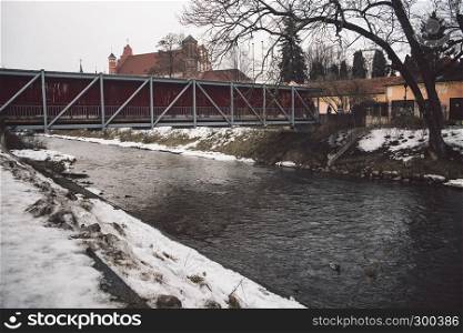 Neris river and art bridge acros at Uzupis district in Vilnius, Lithuania. Winter season