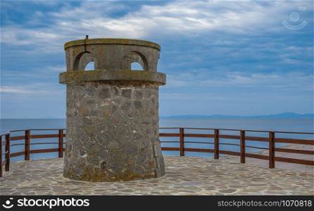 Nessebar, Bulgaria ? 07.09.2019. Old tower on the promenade of Nessebar ancient city, Bulgaria, on a cloudy summer morning. Old tower in Nessebar, Bulgaria