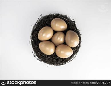 Nest with chicken or bird eggs isolated on a white background top view, copy space pace for text. Nest with chicken or bird eggs isolated on a white background top view, copy space