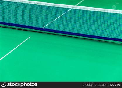 Net of tennis court on green wall background