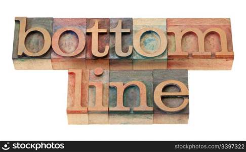 net profit or loss concept - bottom line words in vintage wooden letterpress printing blocks, stained by color inks, isolated on white