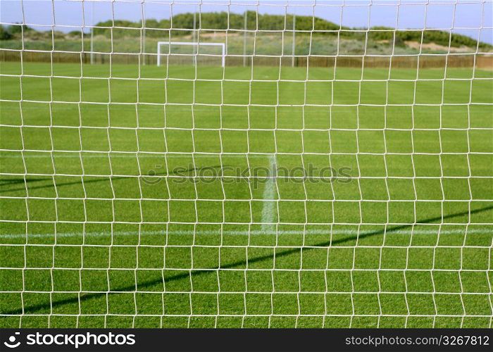 Net soccer goal football green grass field sunny day outdoors