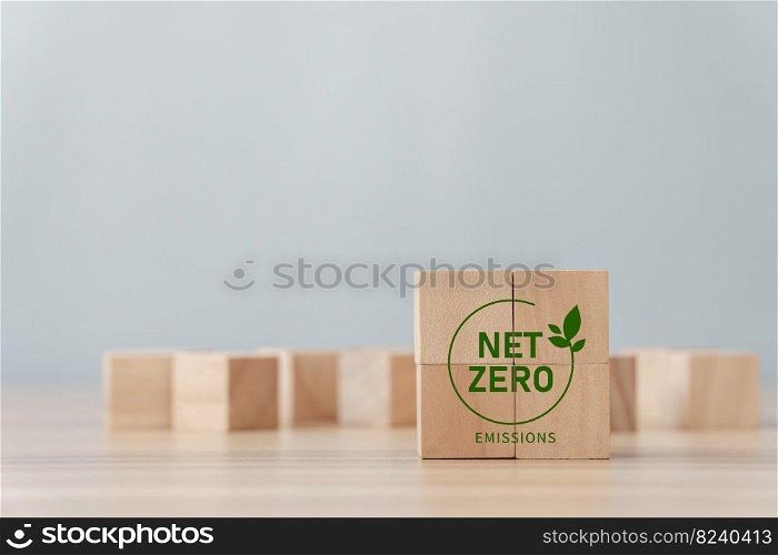 Net Zero and Carbon Neutral concept, green icon on a wooden block. Zero net greenhouse gas emissions target A climate-neutral long-term strategy