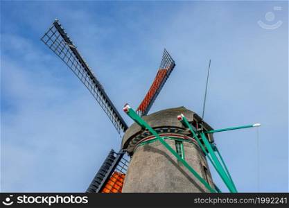 Netherlands. Authentic Dutch windmill against the blue sky. Roof and blades. Roof and Blades of an Authentic Dutch Windmill