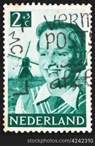 NETHERLANDS - CIRCA 1951: a stamp printed in the Netherlands shows Girl and Windmill, circa 1951