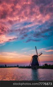 Netherlands rural landscape with windmills at famous tourist site Kinderdijk in Holland on sunset with dramatic sky. Windmills at Kinderdijk in Holland. Netherlands