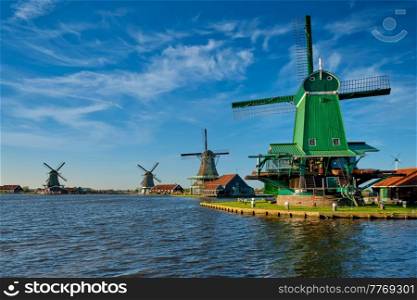 Netherlands rural lanscape Windmills at famous tourist site Zaanse Schans in Holland. Zaandam, Netherlands. Windmills at Zaanse Schans in Holland on sunset. Zaandam, Netherlands