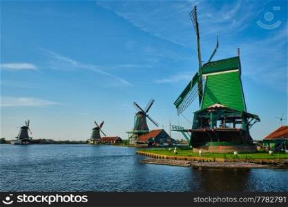 Netherlands rural lanscape - windmills at famous tourist site Zaanse Schans in Holland. Zaandam, Netherlands. Windmills at Zaanse Schans in Holland. Zaandam, Nether