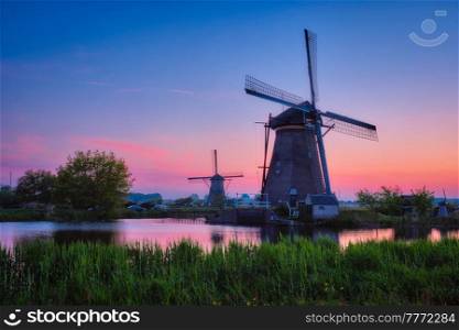 Netherlands rural lanscape with windmills at famous tourist site Kinderdijk in Holland in twilight. Windmills at Kinderdijk in Holland. Netherlands