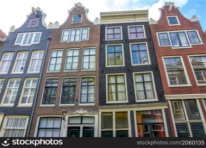 Netherlands. Sunny day in Amsterdam. Facades of authentic Dutch houses. Facades of an Authentic Dutch Houses and Blue Sky