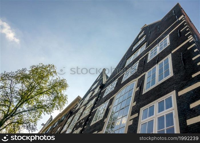 Netherlands. Sunny day in Amsterdam. The facade of an authentic Dutch house. Facade of an Authentic Dutch House and Blue Sky