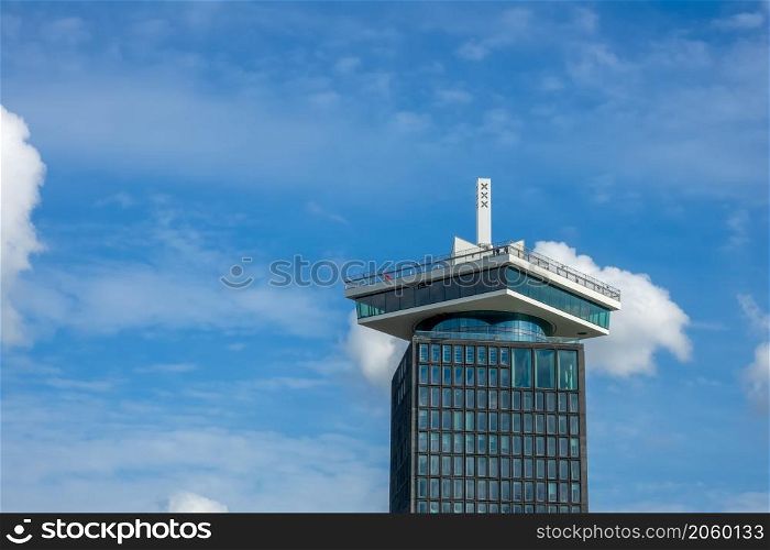 Netherlands. Sunny day in Amsterdam. The top of the ADAM tower against a blue sky with light clouds. Top of the ADAM Tower in Amsterdam Against the Blue Sky