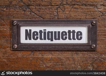 netiqutte (internet etiquette) - file cabinet label, bronze holder against grunge and scratched wood