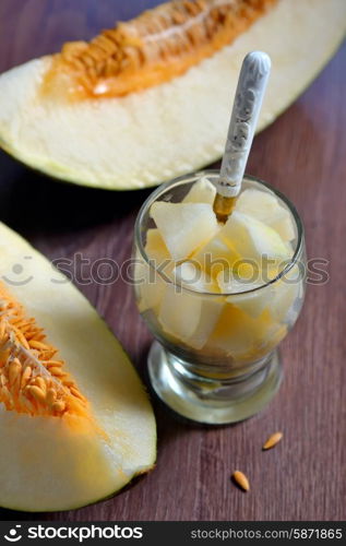 Netted slice melon on old wooden table