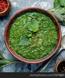 Nettle soup in bowl on wooden surface.Green nettle soup. Green nettle soup