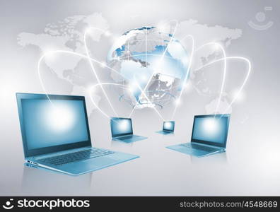 Network concept. Image of laptop with globe illustration at background