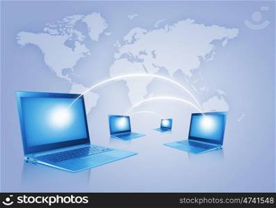 Network concept. Laptops against world map background. Connection and cooperation