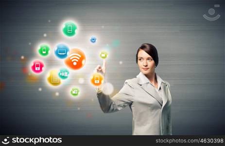 Network connection. Young attractive businesswoman touching media colorful icon