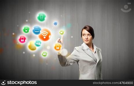 Network connection. Young attractive businesswoman touching media colorful icon